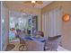 Enclosed patio with tile flooring, ceiling fan, and sitting area overlooking the backyard at 695 Rivendell Blvd, Osprey, FL 34229