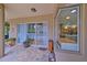 Covered patio with brick flooring and large sliding glass doors offering indoor/outdoor living at 695 Rivendell Blvd, Osprey, FL 34229
