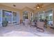 View of screened patio with ceiling fan and seating area at 695 Rivendell Blvd, Osprey, FL 34229
