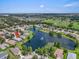 Scenic aerial shot of the property overlooking a picturesque lake with fountain views and mature trees at 7026 43Rd E Ave, Palmetto, FL 34221