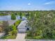 Aerial view of a home with a well-manicured lawn and a lake view at 7026 43Rd E Ave, Palmetto, FL 34221