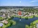Expansive aerial image showcasing the house near a sparkling lake with fountain and neighborhood surroundings at 7026 43Rd E Ave, Palmetto, FL 34221