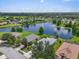 Panoramic aerial view of a community with a central lake and lush landscaping at 7026 43Rd E Ave, Palmetto, FL 34221
