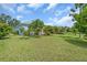 Spacious backyard with verdant lawn, landscaping, and ample space for recreation at 7026 43Rd E Ave, Palmetto, FL 34221