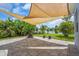 Spacious backyard patio with lake views, shade, firepit, and lush landscaping at 7026 43Rd E Ave, Palmetto, FL 34221