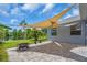 Charming covered patio with a beautiful view of the lake, and fire pit at 7026 43Rd E Ave, Palmetto, FL 34221
