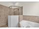 Elegant bathroom featuring glass-enclosed shower and large soaking tub at 7026 43Rd E Ave, Palmetto, FL 34221