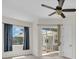 Comfortable bedroom featuring a ceiling fan, multiple windows, and slider access to outdoor space at 7026 43Rd E Ave, Palmetto, FL 34221