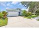 Attractive home featuring a large driveway, attached garage, and well-manicured landscaping at 7026 43Rd E Ave, Palmetto, FL 34221