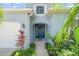 Charming front entrance with landscaped walkway and blue door with a decorative wreath at 7026 43Rd E Ave, Palmetto, FL 34221