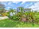 Inviting home exterior with lush landscaping, a spacious driveway, and a well-maintained lawn at 7026 43Rd E Ave, Palmetto, FL 34221