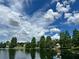 Scenic lake view showcasing mature trees, a beautiful gazebo, and gorgeous sky at 7026 43Rd E Ave, Palmetto, FL 34221