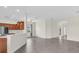 Open-concept living area with wood-style tile flooring adjacent to kitchen area and plentiful natural light at 7026 43Rd E Ave, Palmetto, FL 34221
