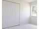 Clean bedroom featuring closet, window, tile floor, and neutral colors at 7164 Gama Ct, North Port, FL 34287