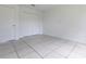 Bedroom with neutral walls, tile flooring, and closet doors at 7164 Gama Ct, North Port, FL 34287