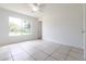 Neutral bedroom featuring tile floors, and a window with views of the outdoors at 7164 Gama Ct, North Port, FL 34287