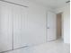 Neutral bedroom featuring tile floors, closet with double doors, and an open doorway at 7164 Gama Ct, North Port, FL 34287