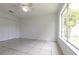 A spacious bedroom with tile floors, neutral walls, and large window at 7164 Gama Ct, North Port, FL 34287