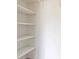 Open closet with built-in shelving and white walls at 7164 Gama Ct, North Port, FL 34287