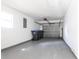 Clean and spacious garage area showing door, and plenty of room for storage and parking at 7164 Gama Ct, North Port, FL 34287