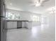 Open kitchen and living area with stainless appliances and marble tile floors at 7164 Gama Ct, North Port, FL 34287