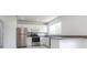 Bright kitchen features stainless steel appliances and white cabinetry at 7164 Gama Ct, North Port, FL 34287