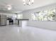 Spacious living room with recessed lighting, ceiling fan, and large windows at 7164 Gama Ct, North Port, FL 34287