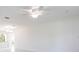 Bright and airy living room featuring a modern ceiling fan, neutral paint, and ample natural light at 7164 Gama Ct, North Port, FL 34287