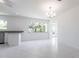 Open-concept living space with marble floors, neutral paint, granite countertops, and stainless steel appliances at 7164 Gama Ct, North Port, FL 34287