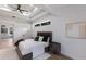 Cozy bedroom with a tray ceiling, modern decor, and a small window adding natural light at 7211 Marston Ct, University Park, FL 34201