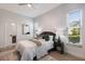 Serene bedroom with soft lighting, neutral tones, and a view into the ensuite bathroom at 7211 Marston Ct, University Park, FL 34201