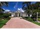Stunning single-story home with a beautifully landscaped yard and inviting brick driveway at 7211 Marston Ct, University Park, FL 34201