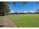 Lush green golf course with players and golf carts visible on a sunny day at 7211 Marston Ct, University Park, FL 34201