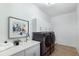 Functional laundry room featuring modern appliances, sink, and plenty of storage cabinets at 7211 Marston Ct, University Park, FL 34201