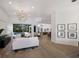 Open concept living area with view of pool through sliding glass doors and views to dining and kitchen at 7211 Marston Ct, University Park, FL 34201