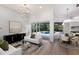 Spacious living room with pool view through sliding glass doors and view to open dining and kitchen at 7211 Marston Ct, University Park, FL 34201