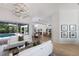 Bright and airy open-concept living area featuring pool views and seamless transition to kitchen and dining at 7211 Marston Ct, University Park, FL 34201