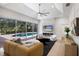 Bright living room with modern fireplace, large slider doors overlooking pool, and ceiling fan at 7211 Marston Ct, University Park, FL 34201