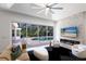 Bright living room with fireplace, large slider doors with view to pool, and contemporary decor at 7211 Marston Ct, University Park, FL 34201