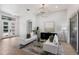 Cozy living room with modern decor, featuring light hardwood floors, and double door entry at 7211 Marston Ct, University Park, FL 34201