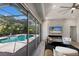 Bright living room with stylish decor, fireplace, and large slider doors with clear view of pool at 7211 Marston Ct, University Park, FL 34201