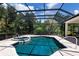 Screened-in pool and hot tub surrounded by a lush, tropical backyard at 7211 Marston Ct, University Park, FL 34201