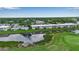 Beautiful aerial view of condominiums nestled beside a scenic golf course with lush green fairways and tranquil waterways at 7301 W. Country Club N Dr # 108, Sarasota, FL 34243