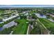 Take in this panoramic aerial view of the property featuring a golf course, lakes, and neatly arranged condominiums at 7301 W. Country Club N Dr # 108, Sarasota, FL 34243