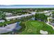 Aerial view of the property situated along lush green golf course and pond at 7301 W. Country Club N Dr # 108, Sarasota, FL 34243