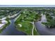Beautiful aerial view of the golf course, lakes, and condominiums offering a peaceful and scenic living environment at 7301 W. Country Club N Dr # 108, Sarasota, FL 34243