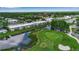 Enjoy this beautiful aerial view of the condominiums and golf course with lush landscaping and serene waterways at 7301 W. Country Club N Dr # 108, Sarasota, FL 34243