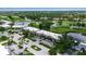 Aerial view of residential neighborhood showcasing manicured landscape, golf course, and waterways at 7301 W. Country Club N Dr # 108, Sarasota, FL 34243