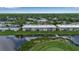 Aerial view of the golf course and pond showing the surrounding community at 7301 W. Country Club N Dr # 108, Sarasota, FL 34243