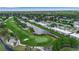 Discover the beautiful aerial view of the golf course community, featuring tranquil waterways and well-maintained condominiums at 7301 W. Country Club N Dr # 108, Sarasota, FL 34243